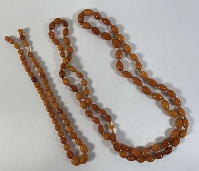 Lot 634 - Two butterscotch egg yolk coloured amber style...