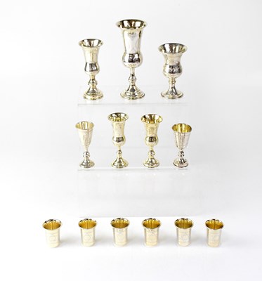 Lot 898 - Seven silver kiddush cups, and a matching set...
