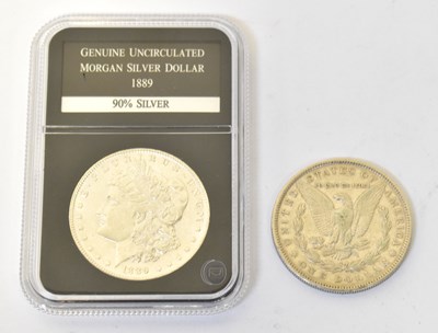 Lot 976 - Two Morgan dollars, one 1881, the other...
