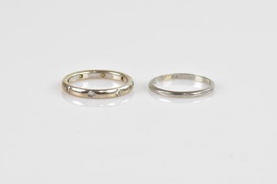 Lot 2474 - An 18ct white gold diamond set wedding band,...