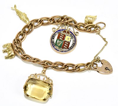 Lot 1266 - A 9ct yellow gold charm bracelet suspending an...