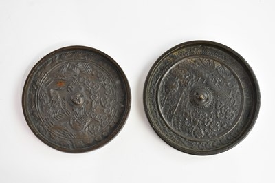 Lot 1584 - Two Chinese bronze mirrors of circular form,...