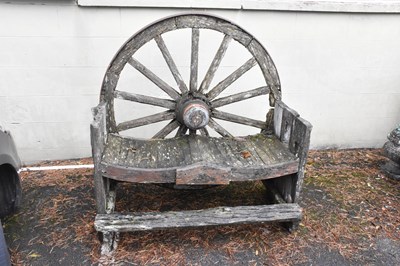 Lot 350 - A vintage cartwheel bench, width 121cm.