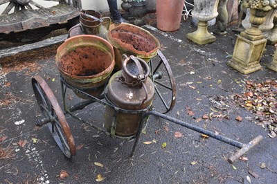 Lot 347 - A cast iron milk cart with two vintage churns...
