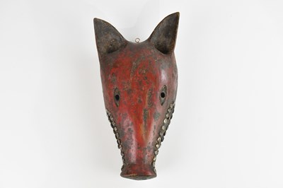 Lot 1501 - A Tanzanian Makonde Mawia red painted helmet...
