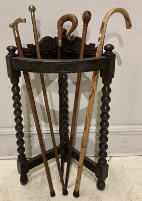 Lot 147 - A 1920s oak demi-lune stick stand housing six...