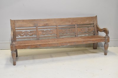 Lot 189 - A vintage teak bench, with carved back and on...