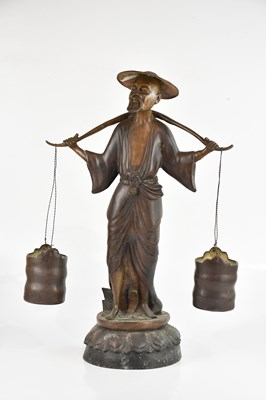 Lot 1669 - A Japanese bronze model of a water carrier...