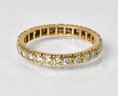 Lot 693 - A yellow metal eternity ring set with diamonds,...