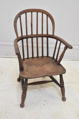 Lot 82 - A 19th century elm seated Windsor elbow chair...