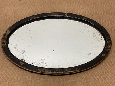 Lot 817 - A lacquered Chinoiserie oval wall mirror, 44 x...