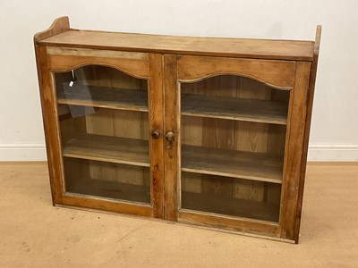 Lot 771 - A pine glazed cabinet with two shelves, height...