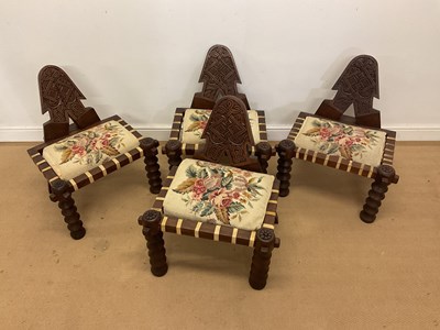 Lot 266 - A set of four Ethiopian carved hardwood low...