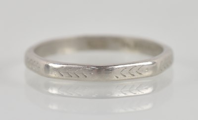 Lot 1344 - A platinum thin band ring with flat sides,...