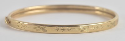 Lot 1456 - A 9ct yellow gold hinged bracelet, with snap...
