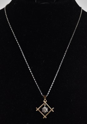 Lot 1405 - A 9ct white gold dainty necklace, with ring...