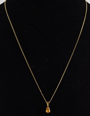 Lot 1410 - A small 9ct yellow gold pendant, with claw set...