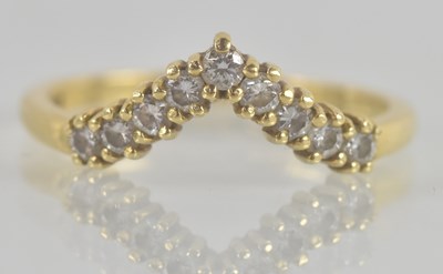 Lot 1327 - An 18ct yellow gold diamond set wishbone ring,...