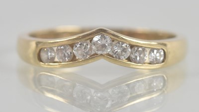 Lot 1359 - A 9ct yellow gold wishbone ring, set with...