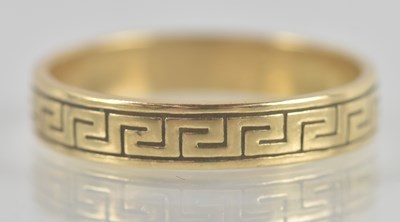 Lot 1351 - A 9ct yellow gold band ring, with Greek key...