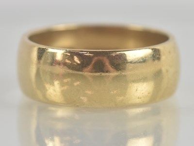 Lot 1318 - A 9ct yellow gold plain wide band ring, size R,...