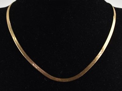 Lot 1401 - A 9ct yellow gold flat braided necklace, with...