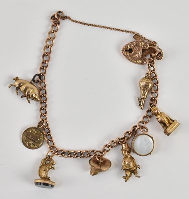 Lot 1451 - A 9ct rose gold charm bracelet, with eight...