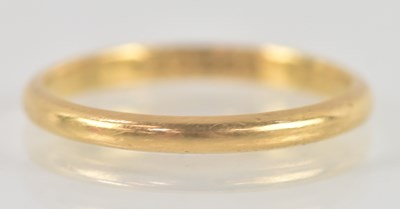 Lot 1324 - A 22ct gold thin band ring, size K/L, approx 2....
