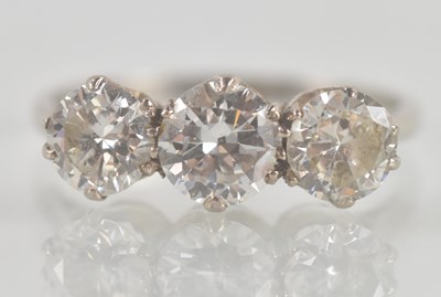 Lot 1292 - A platinum three stone diamond ring, the...