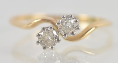 Lot 1320 - An 18ct yellow gold two stone diamond ring,...