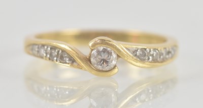 Lot 1331 - An 18ct yellow gold diamond crossover ring,...