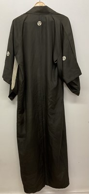 Lot 128 - A Japanese silk kimono, sparsely decorated...