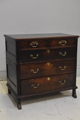 Lot 94 - An 18th century oak chest of two short above...