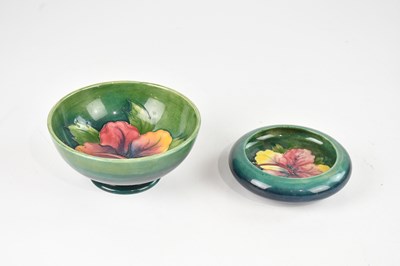 Lot 1190 - WALTER MOORCROFT; a footed bowl decorated in...