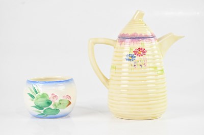 Lot 1428 - CLARICE CLIFF; a coffee pot and cover with...