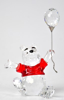 Lot 303 - SWAROVSKI; a seated figure of Winnie-the-Pooh...