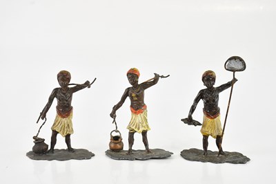 Lot 1228 - Three cold painted lead models of hunters,...