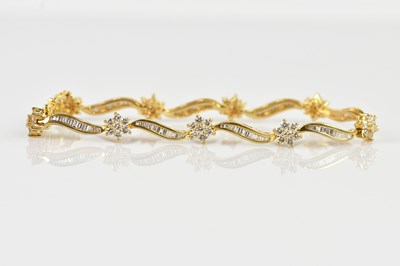 Lot 1182 - A yellow metal diamond set bracelet, set with...