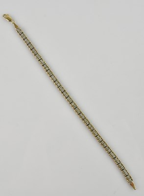 Lot 1195 - A 9ct yellow and white gold diamond set tennis...