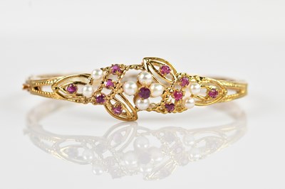 Lot 1245 - A 9ct yellow gold hinged snap bangle, set with...