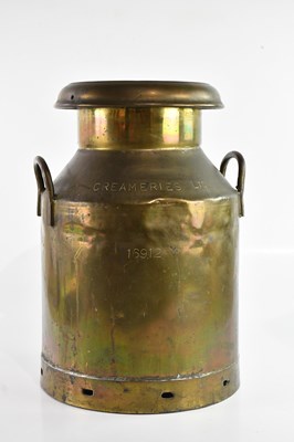 Lot 1172 - A large brass milk churn, inscribed to the lid...