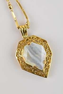 Lot 2054 - An Indian yellow metal moonstone set pendant,...