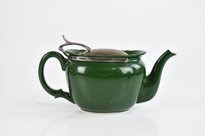 Lot 1254 - HUKIN & HEATH; a green ceramic teapot with...