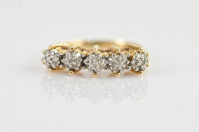 Lot 2538 - A yellow metal dress ring set with a mêlée of...