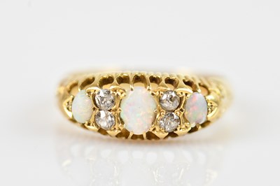 Lot 2381 - An 18ct yellow gold diamond and opal set seven...
