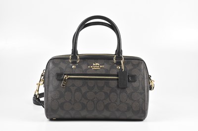 Lot 185 - COACH; a black and brown coated canvas...