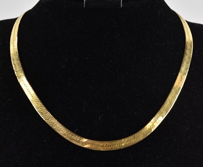 Lot 1376 - A 9ct yellow gold semi-rigid herringbone style...