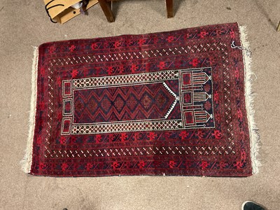 Lot 2163 - A red ground hand knotted woollen Bokhara rug...