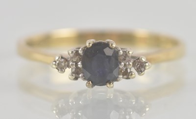 Lot 1361 - A 9ct sapphire and diamond set ring, the...