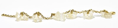 Lot 1260 - A yellow metal bracelet set with six carved...